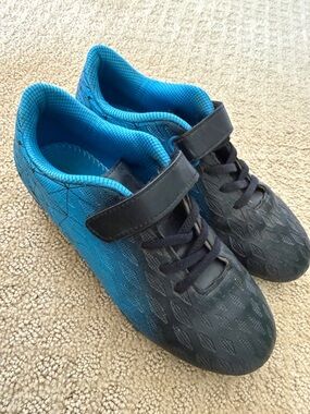 Youth Black and Bright Blue Athletic Cleats.